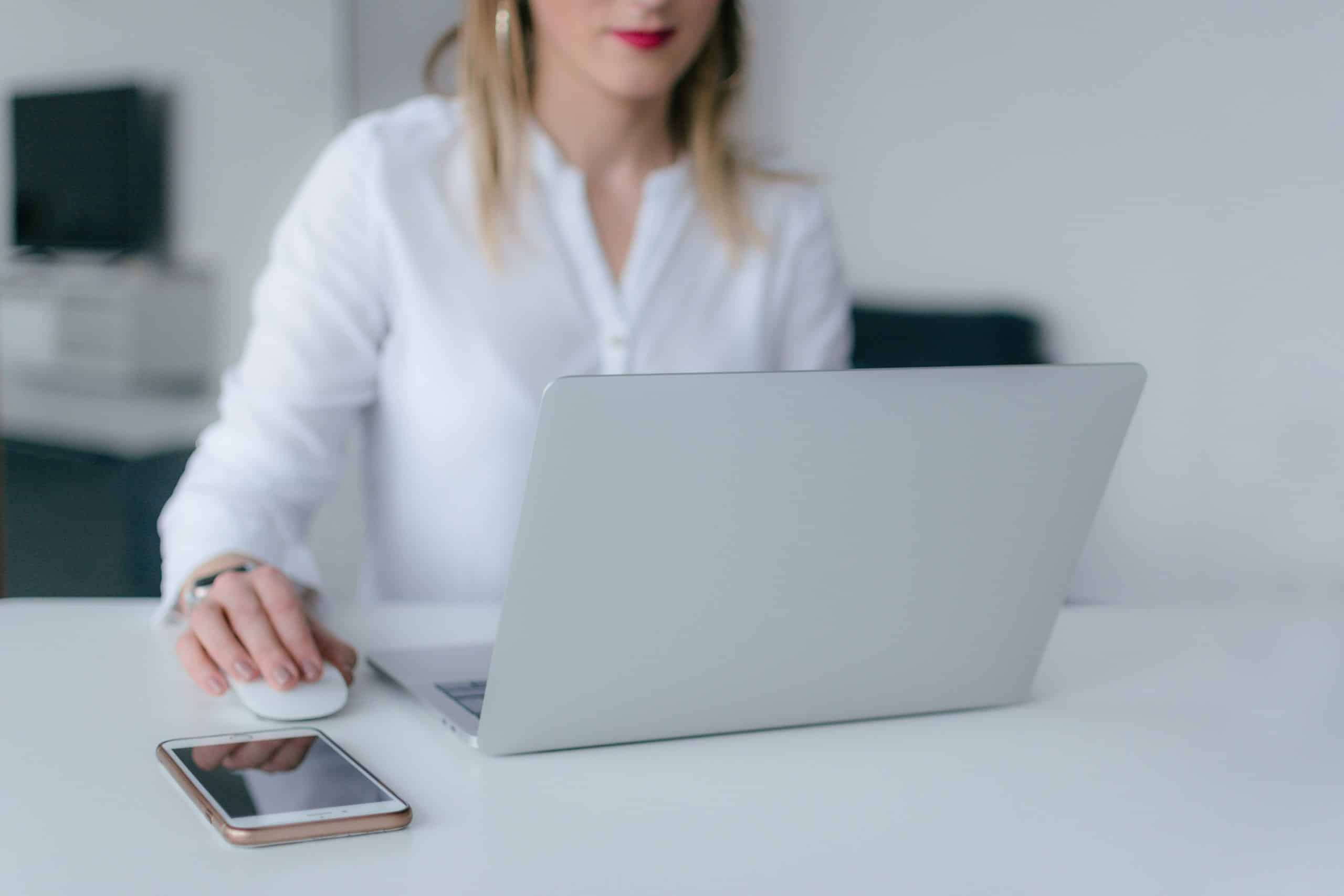 woman-using-silver-laptop-2265488-scaled